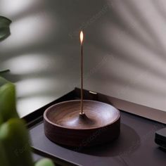 a wooden bowl with a candle in it