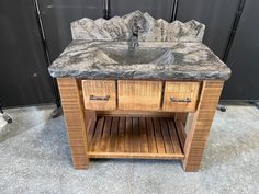 a bathroom sink with two drawers and a marble top