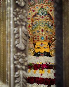 the statue is decorated with flowers and other decorations