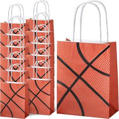 three orange shopping bags with black and white designs on the front, two are empty