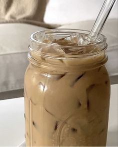 a glass jar filled with ice cream on top of a table