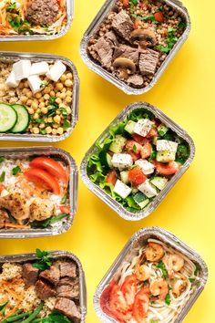 six takeout containers with different types of food in them on a yellow table top