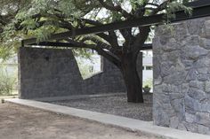 an outdoor area with stone walls and trees