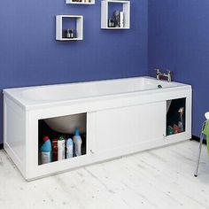 a white bath tub sitting next to a green wall