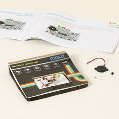 an electronic book with instructions and pictures on the cover is open to show how it works