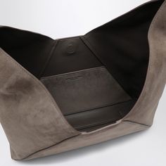 This hobo bag is like that perfect cup of tea, comforting and effortlessly stylish. Made with the softest suede in a rich dark grey, it’s your go-to for both casual outings and special occasions. Plus, the little details like the adjustable handle and magnetic fastening make it as practical as it is chic. Adjustable top handle for customizable comfort Magnet fastening for easy access Embossed lettering logo on the front for a touch of elegance Perfect Cup Of Tea, Hobo Handbag, Hobo Style, Lettering Logo, Grey Suede, Leather Cap, Boot Pumps, Hobo Handbags, Gray Suede