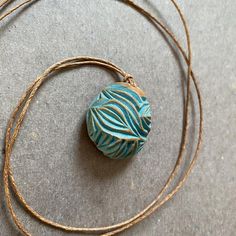 Carved avocado pit necklace with blue-green accents Chip | Etsy Unique Green Carved Necklace, Blue Nature-inspired Round Pendant Necklace, Earthy Handmade Blue Necklace, Unique Etched Blue Jewelry, Unique Blue Etched Jewelry, Fair Trade Nature-inspired Jewelry For Gifts, Nature-inspired Fair Trade Jewelry For Gifts, Etched Blue Jewelry For Gift, Fair Trade Turquoise Jewelry Gift