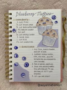 a recipe book with blueberry muffins written in cursive writing on it