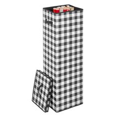 a black and white gingham shopping bag next to a box with cookies in it