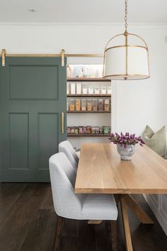 a dining room table with chairs and a light fixture