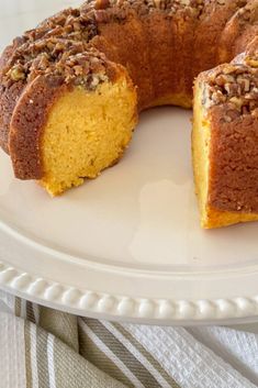 a bundt cake on a plate with one slice cut out