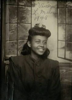 an old black and white photo of a woman