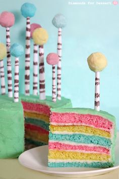 a slice of cake with colorful frosting and candy sticks sticking out of it's side