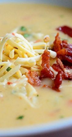 a bowl of soup with noodles, bacon and cheese