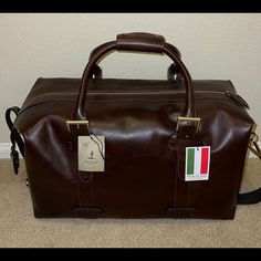 100% Genuine Leather 20”W X 9”D X 11” H Made In Italy Luxury Shopping Duffle Shoulder Bag, Luxury Satchel Duffle Bag For Shopping, Luxury Shopping Duffle Bag Satchel, Classic Business Travel Bag With Dust Bag Included, Classic Business Travel Bag With Dust Bag, Luxury Double Handle Duffle Bag For Shopping, Designer Leather Duffle Bag With Large Capacity, Leather Bags For Business Trips With Dust Bag, Elegant Leather Luggage With Top Handle