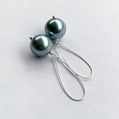 These light blue pearl earrings are perfect for date night or a wedding!  Silver plated kidney ear wires featuring chunky 20mm round metallic light blue faux pearls and measuring 3 inches in total earring length.  A beautiful sheen and unique color!  Lightweight too :) Item is carefully packaged and shipped via USPS in a sturdy protective mailer. Check out more fabulous jewelry and enter my shop here: https://www.etsy.com/shop/jewelbytessyla View the positive feedback I've received from customer Blue Teardrop Pearl Drop Earrings, Blue Dangle Pearl Drop Earrings, Blue Pearl Drop Dangle Earrings, Elegant Blue Hypoallergenic Teardrop Earrings, Blue Pearl Drop Bridal Earrings As Gift, Blue Pearl Dangle Earrings, Blue Pearl Drop Earrings For Party, Formal Blue Pearl Earrings, Elegant Blue Dangle Pearl Earrings