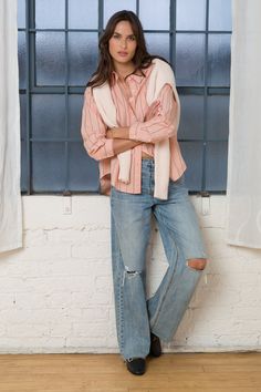 This Randall Peach Stripe Shirt is the perfect addition to your wardrobe. The long sleeve boyfriend shirt features a single chest pocket and a high low hem, making it both stylish and functional. The classic striped design adds a touch of sophistication to any outfit. Stay comfortable and fashionable with this must-have piece. Material: 100% Cotton Machine wash cold or hand wash Color: Peach Stripe Model is 5'9" and wearing a size S Imported Chic Orange Cotton Blouse, Trendy Orange Cotton Blouse, Summer Peach Cotton Shirt, Peach Cotton Summer Shirt, Trendy Cotton Blouse With Rolled Sleeves, Casual Peach Blouse For Fall, Chic Peach Cotton Top, Relaxed Cotton Collared Blouse, Casual Peach Blouse For Day Out