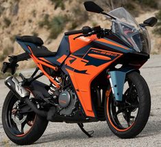 an orange and black motorcycle parked on the street