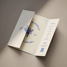 the inside of an open wedding card with blue writing on it and a snowflake