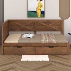 a bed with two drawers and a painting on the wall