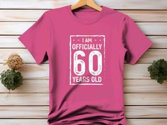 60th Birthday TShirt Officially 60 Years Old Shirt Gift For Him Her 60 Birthday T-Shirt Group Shirts Matching Grunge Tee Unisex T Shirt Chose white or black print. No other customization is offered. Check our other listings or contact us for other years.  Unisex/Men's Sizing This is a basic tee. Nothing special. It is a well crafted cotton (some colors are blended), well sized t-shirt. Nothing more. It does not include our any of our packaging, is not super soft, but is very durable and comforta Pink Short Sleeve Top For Anniversary, Casual Short Sleeve Shirt For Anniversary, Pink T-shirt With Letter Print For Anniversary, Pink Crew Neck T-shirt For Anniversary, Casual Short Sleeve T-shirt For Anniversary, 60th Birthday Tshirt, 60 Birthday, Grunge Tee, Dark Chocolate Brown