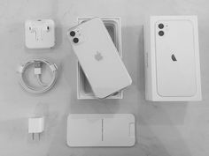 an apple iphone is sitting in its box next to the charger and other accessories