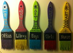 four colorful paint brushes with the words office library on them