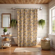 a bath room with a shower curtain and a rug on the floor next to a sink