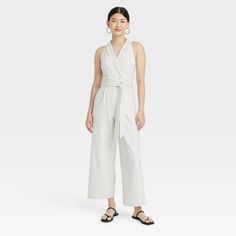 This Overt Occasion Jumpsuit from A New Day™ has you covered for everyday wear or special occasions in chic style. The full-length jumpsuit is fashioned with a notched collar, double-breasted front with buttons, and a matching fabric belt for a shapely, put-together look. It's made of a midweight fabric blend and has a sleeveless, wide-leg silhouette, creating a breezy look that's perfect for warm-weather dressing. Style this woven jumpsuit with sandals or pumps and your fave accessories for a f Chic V-neck Jumpsuits And Rompers With Button Closure, Spring Button Closure Jumpsuits And Rompers For Day Out, Spring Day Out Jumpsuits And Rompers With Button Closure, Formal Jumpsuits And Rompers With Button Closure, Spring Daywear Jumpsuits And Rompers In Overall Style, Spring Workwear V-neck Jumpsuit, Spring V-neck Jumpsuits And Rompers For Work, Elegant V-neck Jumpsuits And Rompers For Daywear, Spring Daywear Jumpsuits And Rompers With Button Closure