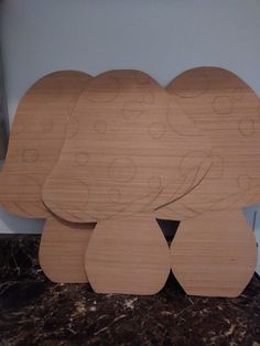 three wooden elephants are sitting on the counter