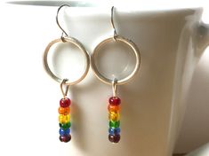 "Love these gorgeous colorful rainbow bead earrings! One of a kind earrings! They will go with so many outfits and make a beautiful statement! These earrings dangle about 2\" long and lightweight. I can make more of these earrings if you need more pairs. Just message me! A great gift for that special someone who has everything! Check out my other mixed metal earrings! https://www.etsy.com/shop/HeidiKindFinds?ref=hdr_shop_menu&search_query=mixed+metal+earrings" Nickel-free Rainbow Round Beaded Earrings, Handmade Rainbow Earrings For Everyday Wear, Handmade Rainbow Earrings For Everyday, Rainbow Dangle Earrings For Everyday, Nickel Free Rainbow Beaded Earrings For Gifts, Nickel-free Round Rainbow Beaded Earrings, Rainbow Round Earrings With Colorful Beads, Everyday Multicolor Dangling Beads Earrings, Rainbow Nickel-free Dangle Hoop Earrings