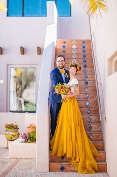 a man and woman are standing on the stairs