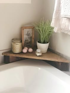 a bathroom with a bathtub, potted plant and other items on the shelf