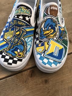 Custom, hand painted slip on Vans University of Delaware Blue Hens sneakers. Can be done in Converse with your school or logo! Contact me to create your custom pair! Blue Custom Artwork Sneakers, Artistic Blue Custom Sneakers With Waterproof Paint, Custom Hand Painted Blue Sneakers, Custom Blue Hand Painted Sneakers, Artistic Custom Blue Sneakers For Streetwear, Artistic Blue Custom Sneakers For Streetwear, Blue Custom Artwork High-top Sneakers, Blue High-top Sneakers With Custom Artwork, Blue Sporty Custom Hand Painted Sneakers