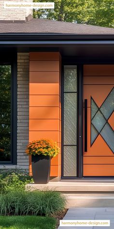 an orange front door with two planters on each side