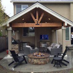 an outdoor living area with chairs and a fire pit