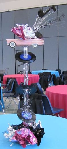 a glass vase filled with flowers sitting on top of a blue tablecloth covered table