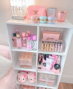 a white shelf filled with lots of pink items