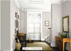 a hallway with orange walls and white trim on the door, brown rug in front