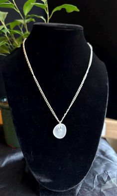 Discover the timeless allure of our frosted white pendant necklace, a unique piece of wearable art that embodies the beauty and tranquility of Lake Michigan. This exquisite pendant features genuine sea glass, meticulously handpicked from the shores of Lake Michigan and expertly handcrafted into a one-of-a-kind accessory. Specifications: -Pendant length:  around 1 inches -Amount of sea glass: 1 piece -Chain Length: 16" stainless steel nickel free chain adjustable -Clasp:lobster claw  adjustable -Materials: Genuine Lake Michigan sourced Sea Glass,stainless steel nickel-free metal chain, wire Features: -Authentic Lake Michigan Sea Glass: Carefully handpicked from the pristine shores of Lake Michigan, ensuring a one-of-a-kind piece that is never reshaped. When picking pairs we look for similar Minimalist Handmade Necklace With Recycled Glass, Minimalist Handmade Necklaces With Recycled Glass, Recycled Glass Round Pendant Necklace Gift, Handmade Minimalist Clear Necklace, White Sea Glass Jewelry Gift, Elegant Handmade Sea Glass Necklace, White Minimalist Glass Jewelry, Round Recycled Glass Necklaces For Gifts, Minimalist Recycled Glass Necklaces For Gifts