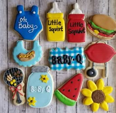 decorated cookies are arranged in the shape of baby's first names and other items