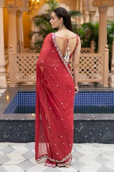 Gajjri pre-draped saree with mirror embroidery. Comes with a padded blouse and a petticoat.
Components: 3
Pattern: Embroidered
Type Of Work: Mirror
Neckline: Round
Sleeve Type: Sleeveless
Fabric: Semi crepe, Georgette, Chanderi, Lining: Semi crepe
Color: Red
Other Details: 
Attached lining
Product Weight: 1 Kg
Model Height: 5ft 9inches, wearing size S
Closure: Blouse - Back tie-up
Occasion: Sangeet - Aza Fashions Pre Draped Saree, Saree Georgette, Draped Saree, Mirror Round, Vacuum Storage, Drape Saree, Indian Wedding Wear, Georgette Blouse, Gold Border