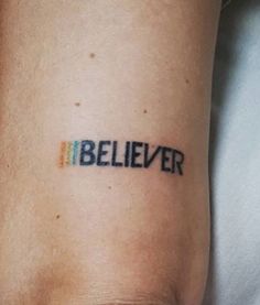 a person with a tattoo on their arm that reads, believer and has the word below it