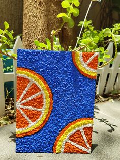 an orange slice is painted on a blue block