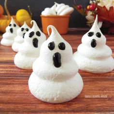 small white ghost meringues are sitting on a table