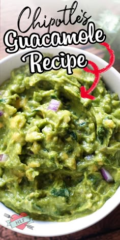 a bowl filled with guacamole on top of a wooden table