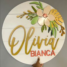 a person holding up a sign that says elvira bianca on it