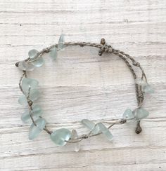 Gorgeous beach bracelet or anklet made with light mint green sea glass pebbles on our durable hand spun rope cord. Pure island style! Easy and secure adjustable slide knot closure allows for easy on and off. This bracelet/anklet is completely waterproof and metal free making it perfect for anyone with skin sensitivities and is a wonderful and unique gift for those hard to shop for friends and family on your list, especially the beach lovers! Color: Mint Green Size: Available in three sizes. Brac Handmade Adjustable Coastal Beaded Bracelets, Green Beaded Bracelets With Adjustable Cord For Beach, Adjustable Seafoam Jewelry For Gifts, Adjustable Seafoam Jewelry As Gift, Beach Jewelry With Green Sliding Knot, Green Adjustable Cord Beach Bracelet, Green Adjustable Cord Bracelets For Beach, Adjustable Recycled Glass Bracelets As Gift, Handmade Adjustable Sea Glass Bracelets