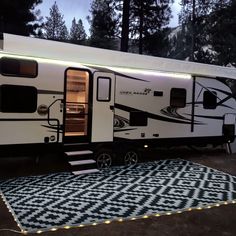 an rv is parked in the driveway with its lights on