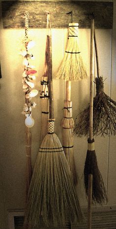 brooms and other items hanging on a wall